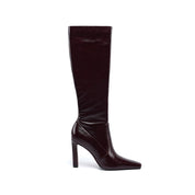 A single knee-high boot in a glossy deep burgundy patent leather, shown from a side profile against a plain white background.